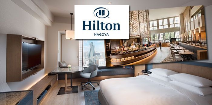 Hilton Nagoya hotel room interior with a bed, desk, and restaurant view.