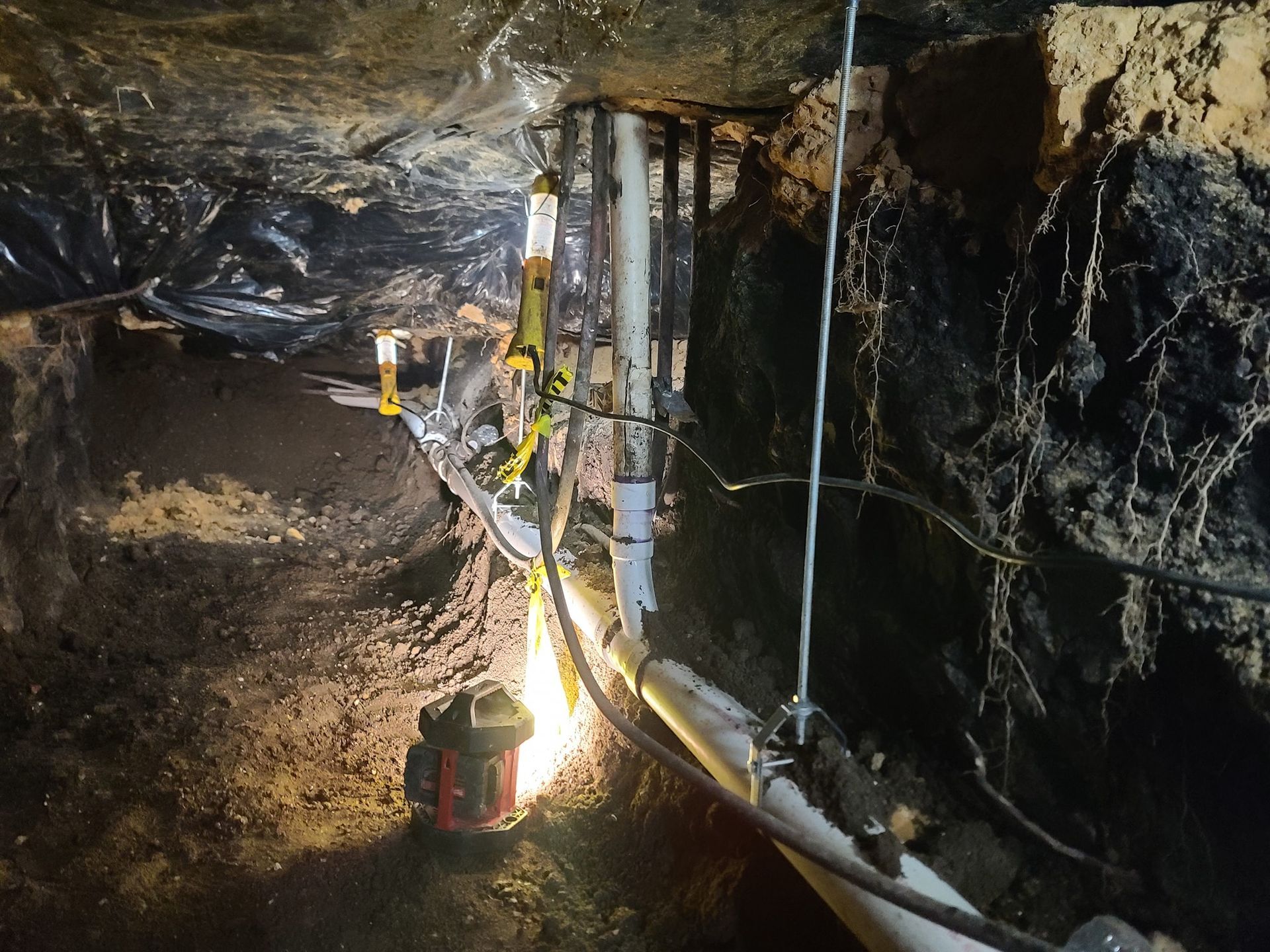 A very dark cave with a lot of pipes and wires