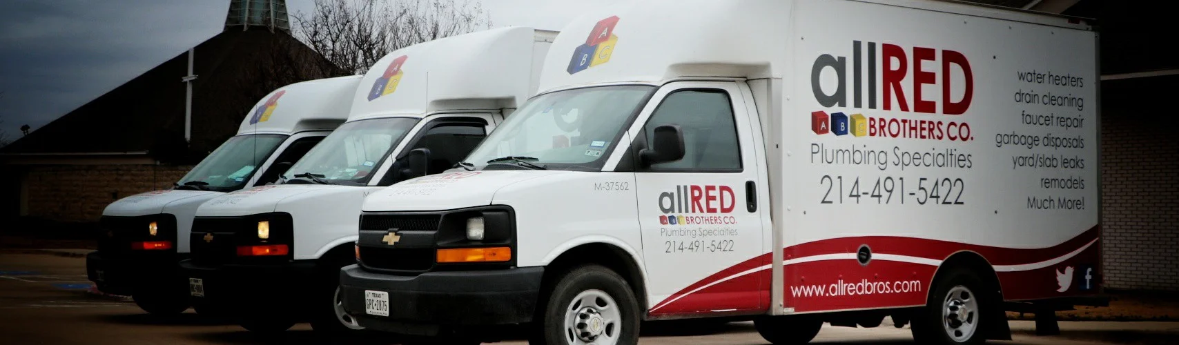 Three Allred trucks are parked next to each other