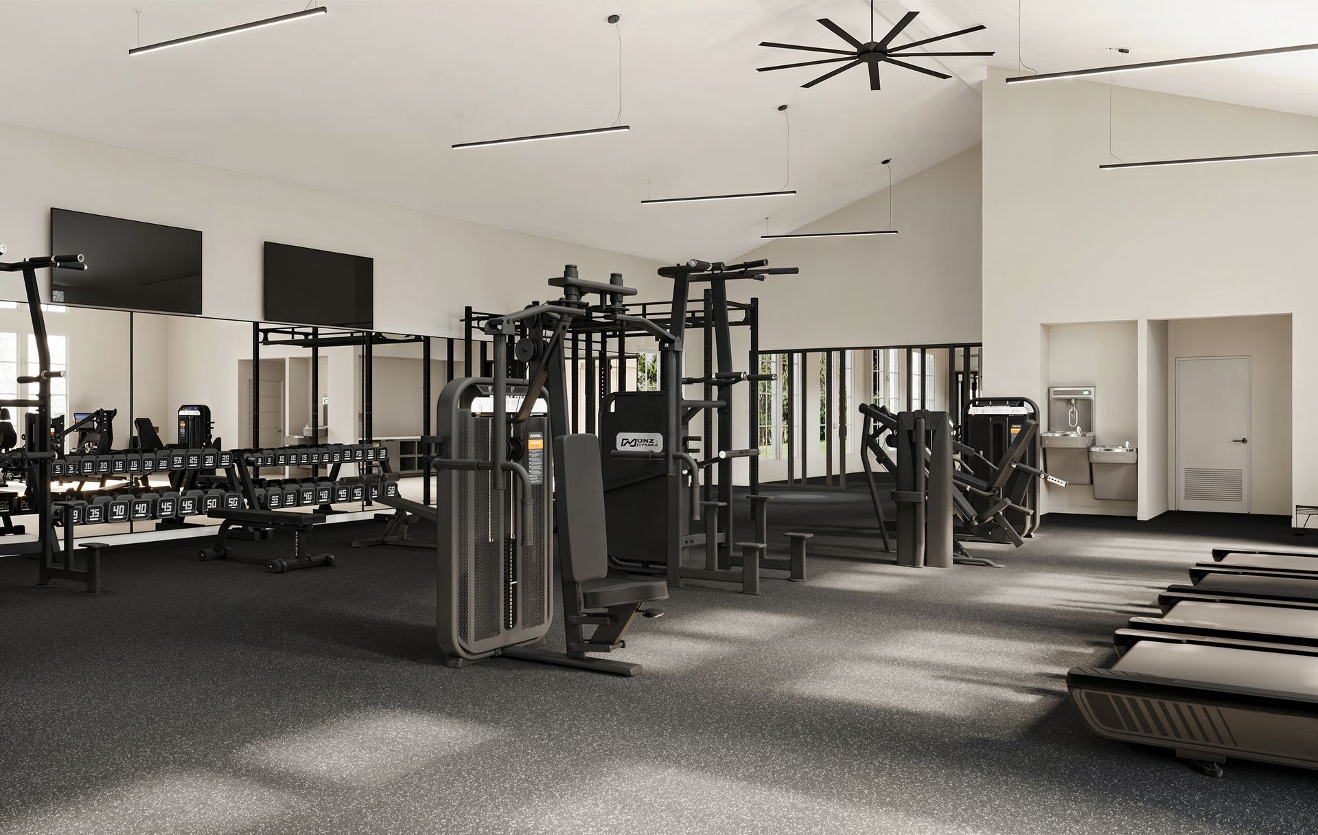 White buildings with dark roofs, cars parked in front, trees framing the sky.