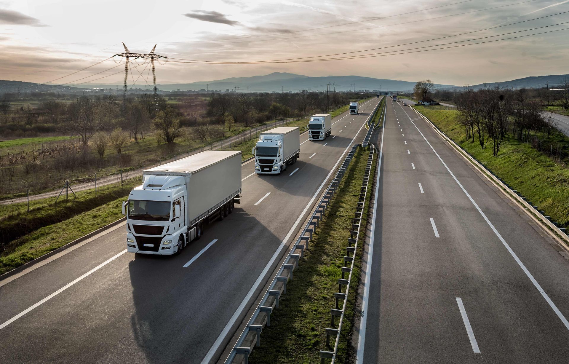 a group of trucks are driving down a highway