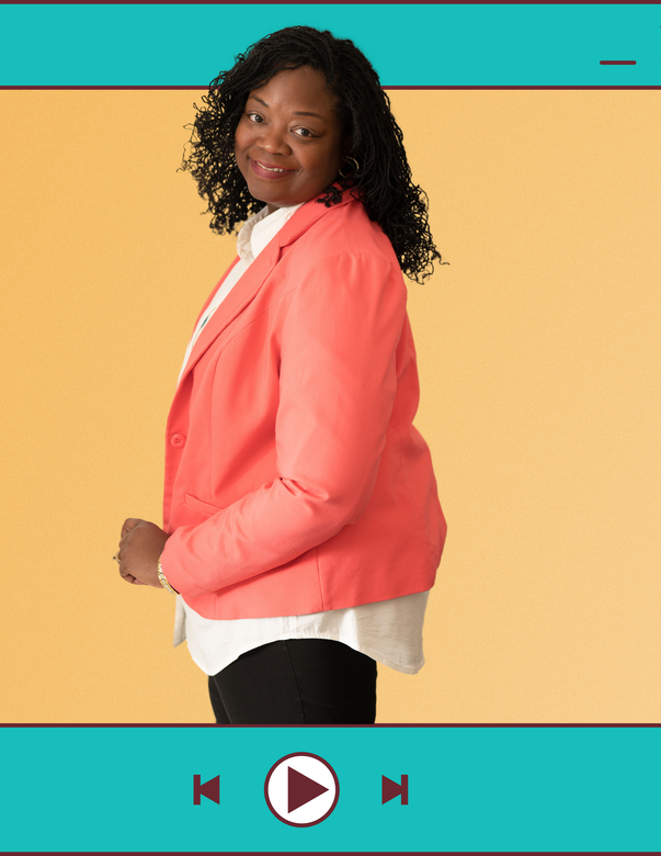 A woman in a pink jacket is standing in front of a video player.
