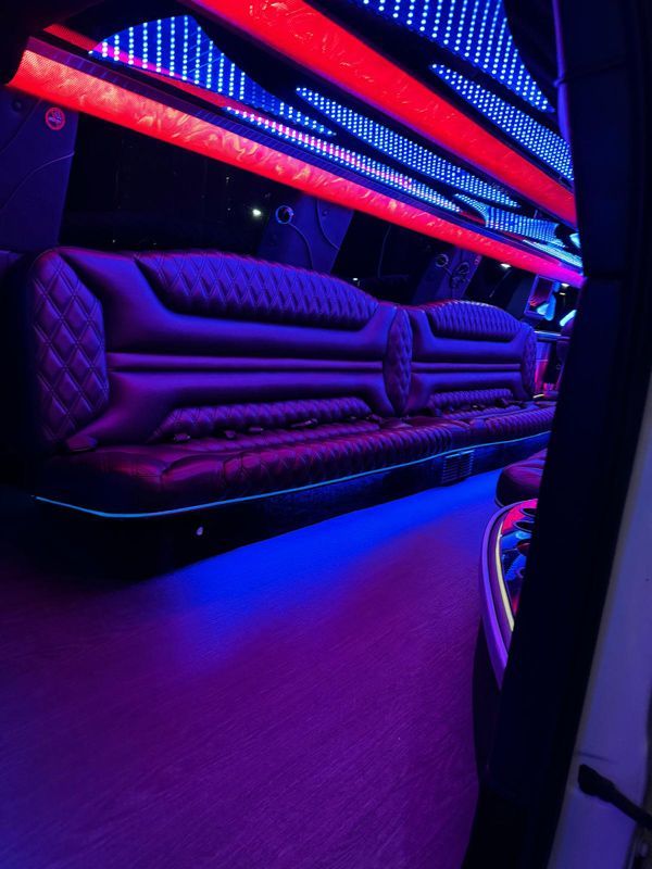 The inside of a limousine with purple and red lights
