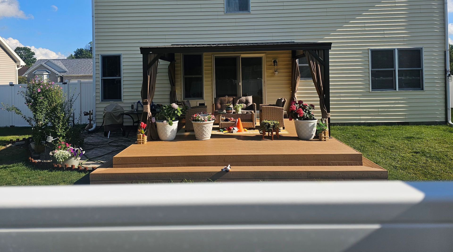 A house with a wooden deck in front of it.