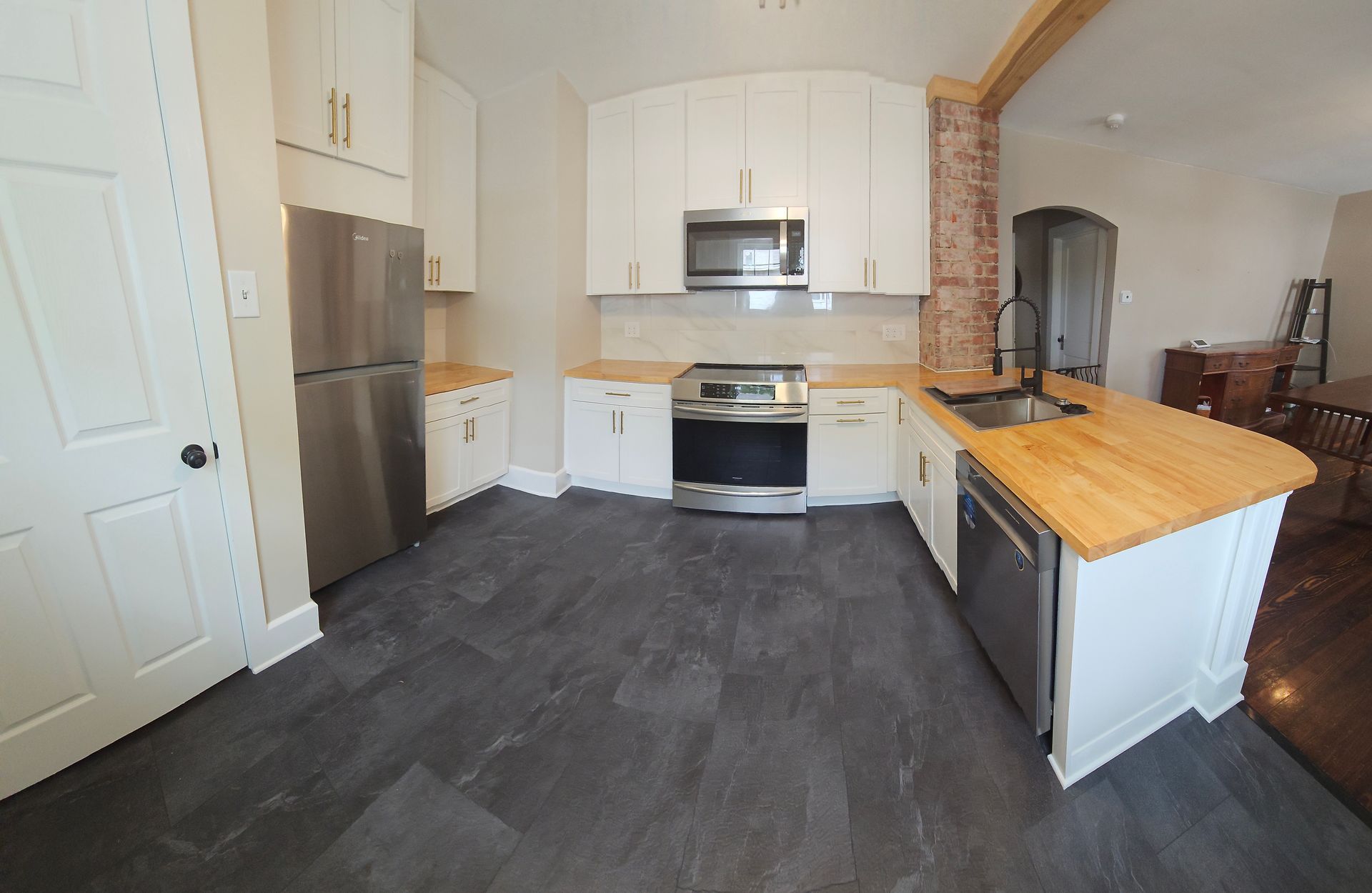 A kitchen with white cabinets and stainless steel appliances