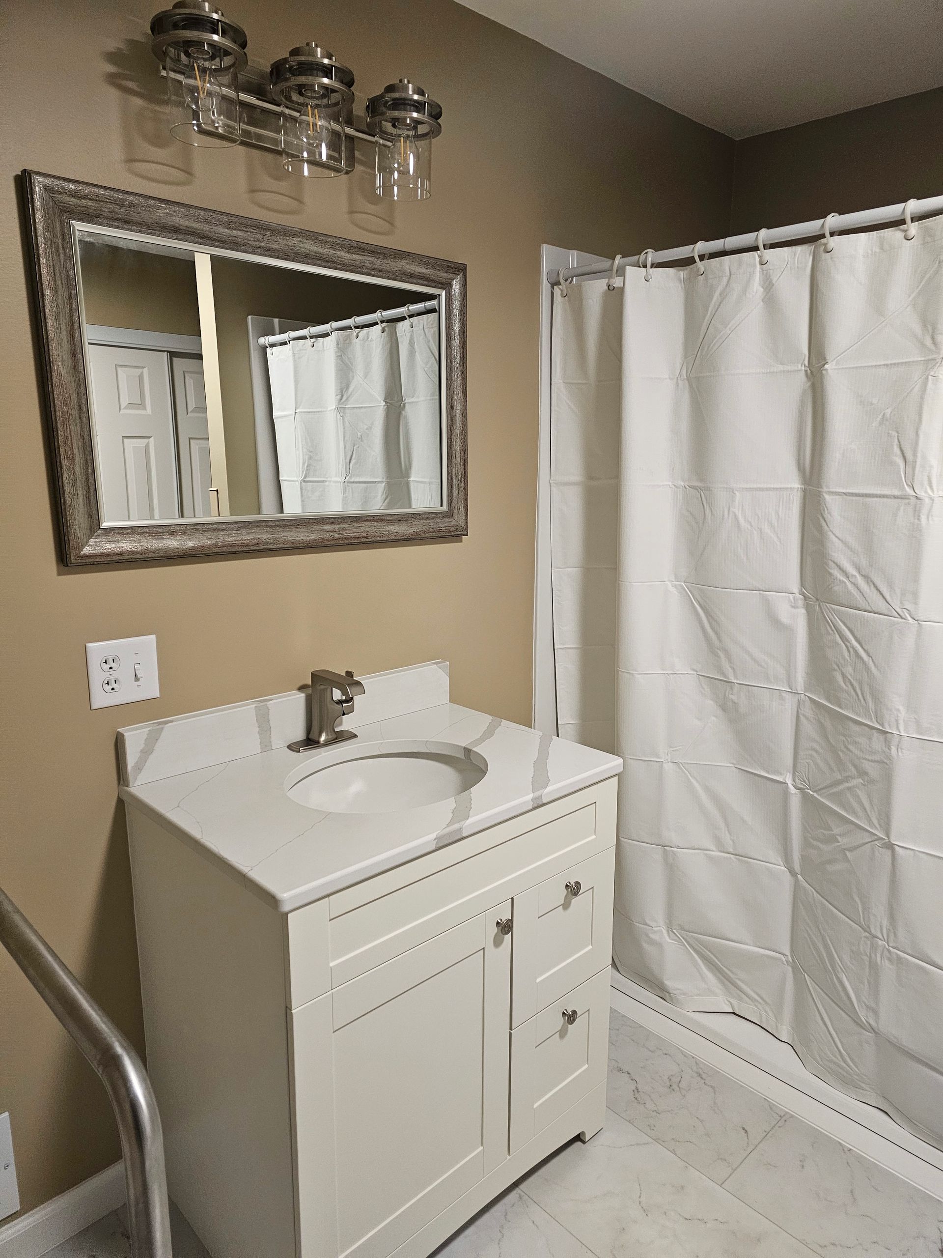 A bathroom with a sink , mirror and shower curtain
