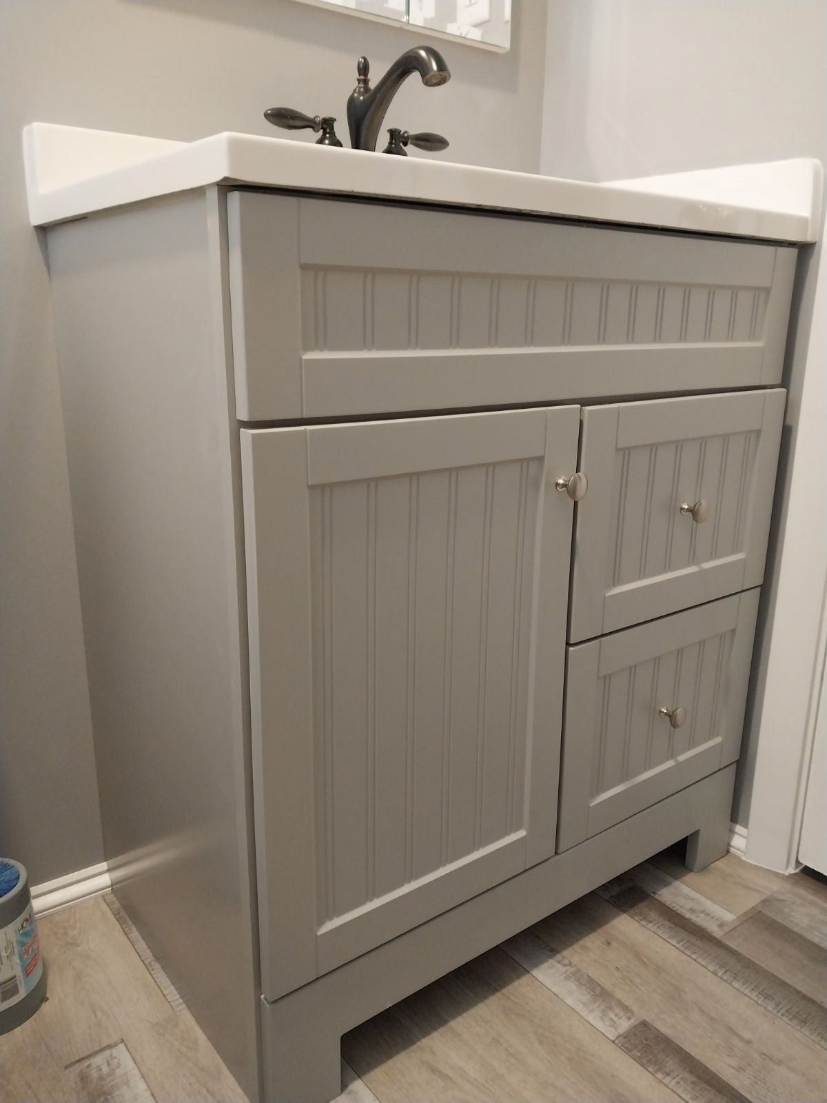 A bathroom vanity with a sink and a mirror.