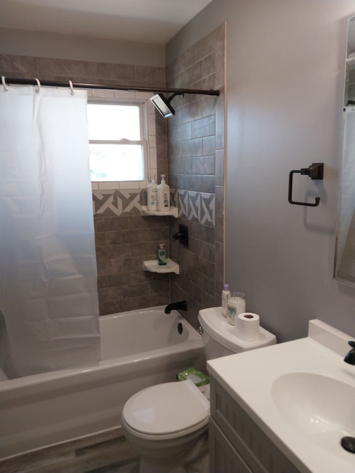 A bathroom with a toilet a sink and a bathtub