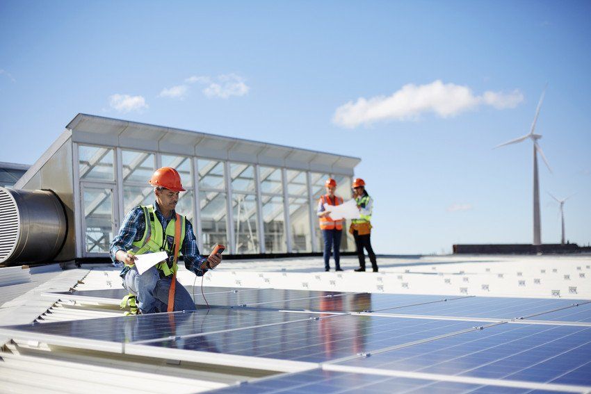 Engineer testing solar panels at sunny power plant