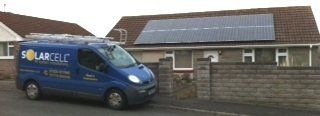 blue van outside home with solar panels