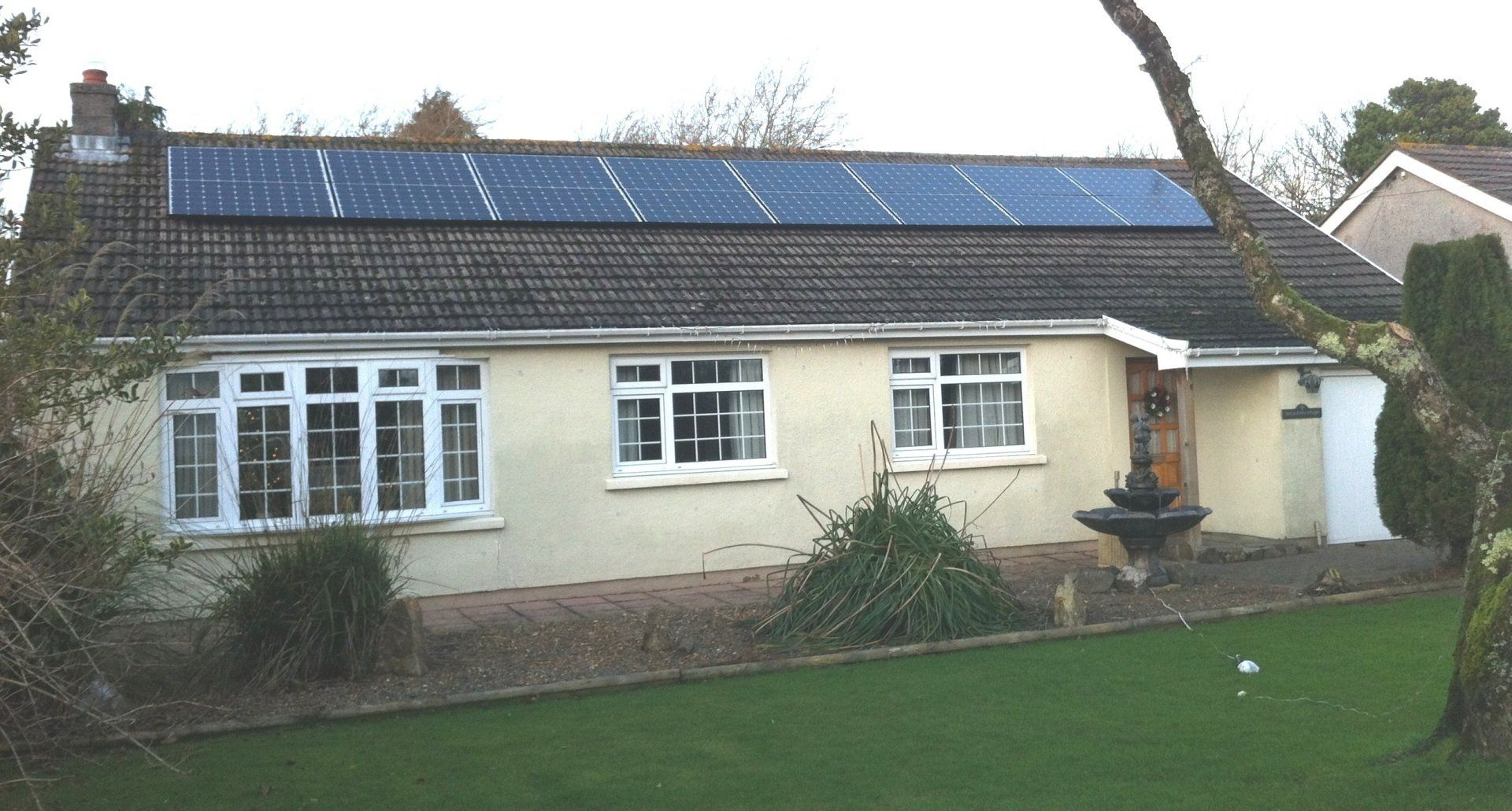 bungalow cottage with solar panels on roof