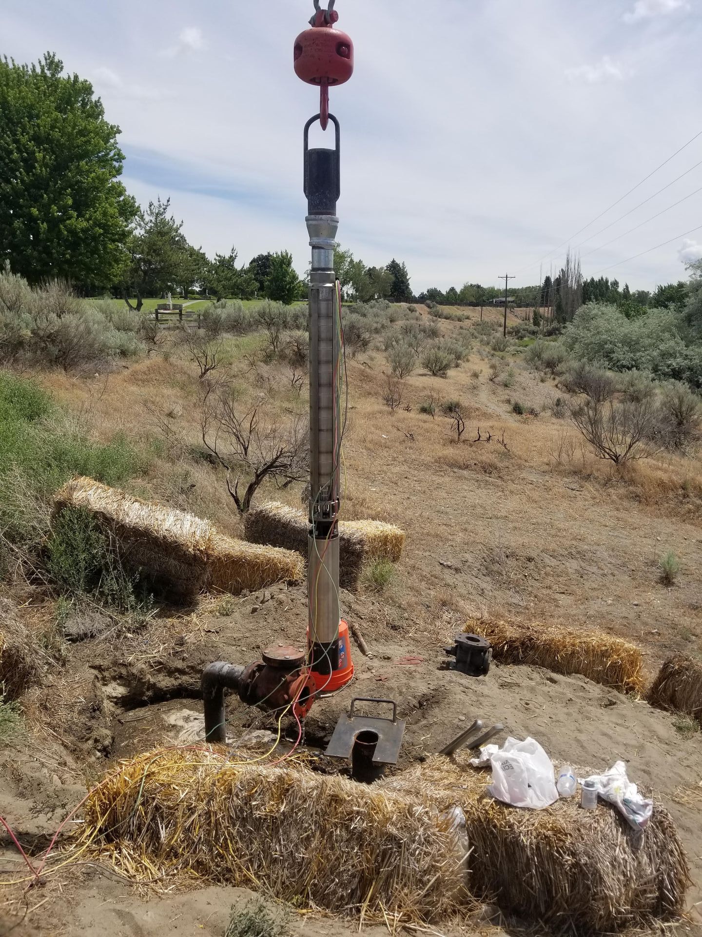 A red buoy is sitting in the middle of a dirt field