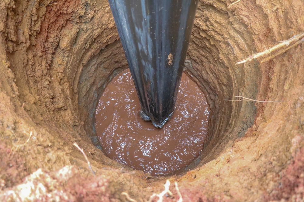 Well Being Drilled With Liquid, in Brown Soil — Atherton Location Services In Mareeba, QLD