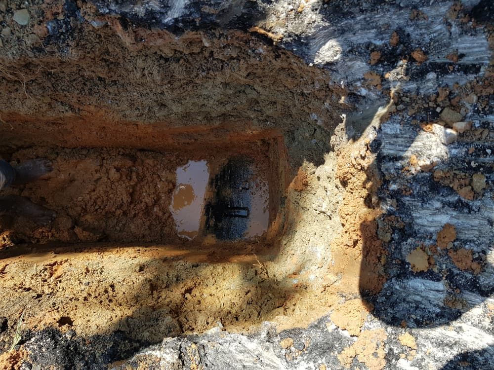 A Hole In The Ground With Water Coming Out Of It — Atherton Location Services In Atherton, QLD