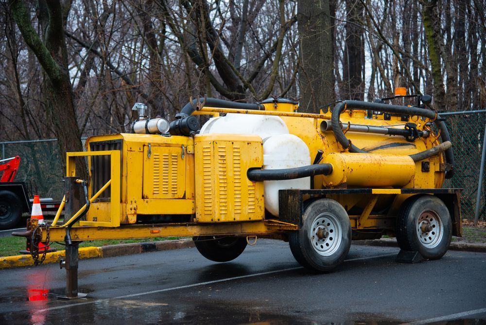 Yellow Vacuum Truck Trailer Parked on a Wet Surface — Atherton Location Services In Mareeba, QLD