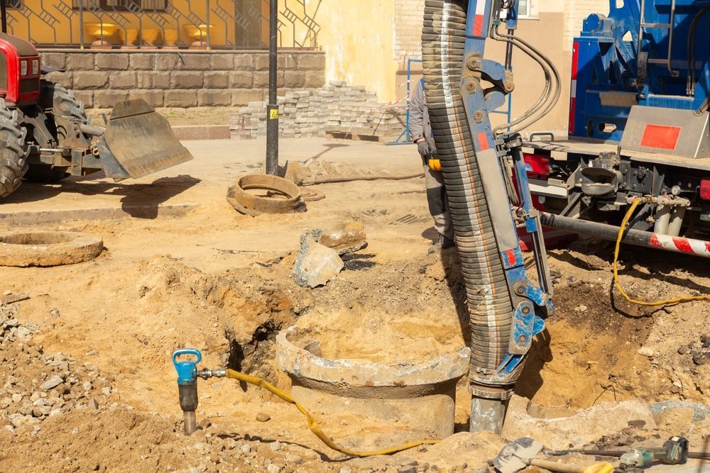 A Construction Site With A Tractor And A Vacuum Truck — Atherton Location Services In Atherton, QLD