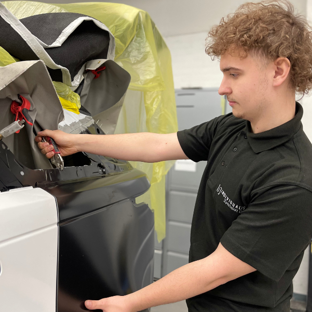 Daniel Davies Repairs in the Panel Department 