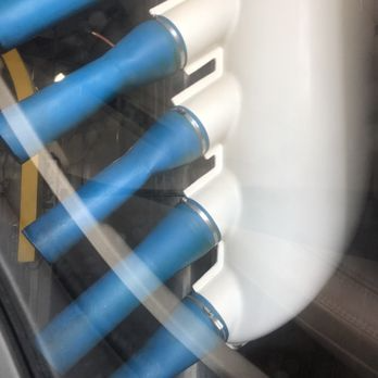 Blue and white pipes in a circular configuration, possibly machinery or plumbing.