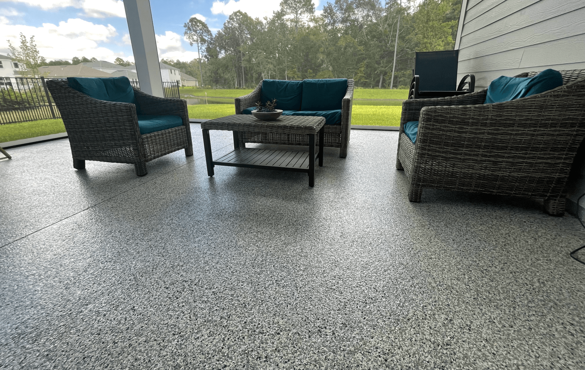 Gray colored epoxy flooring  on covered Jacksonville porch.  