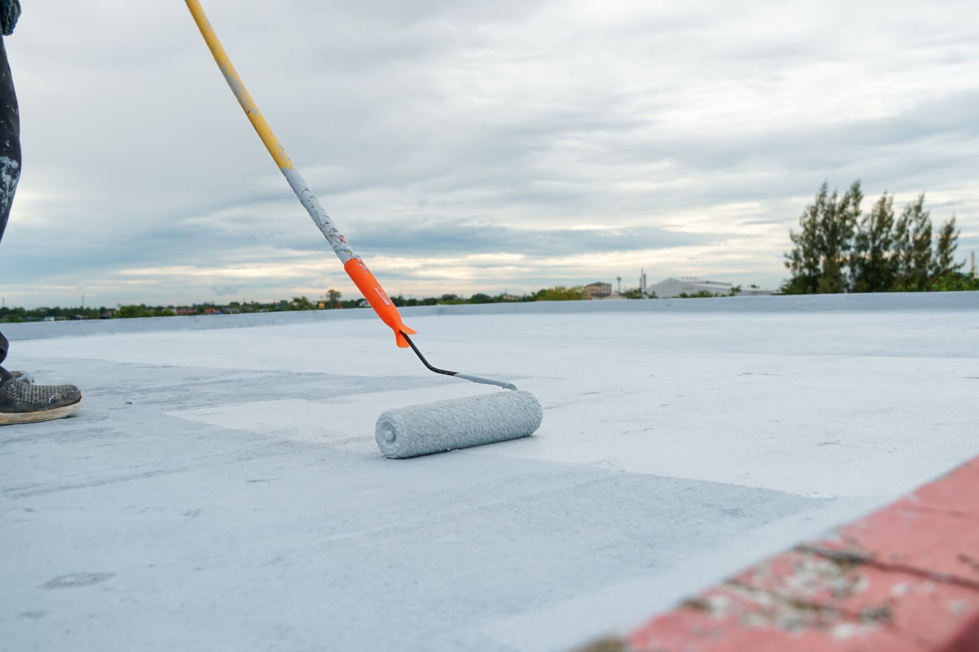 Hand-painted gray flooring with paint rollers for waterproofing, reinforcing net, and repairing waterproof deck flooring.