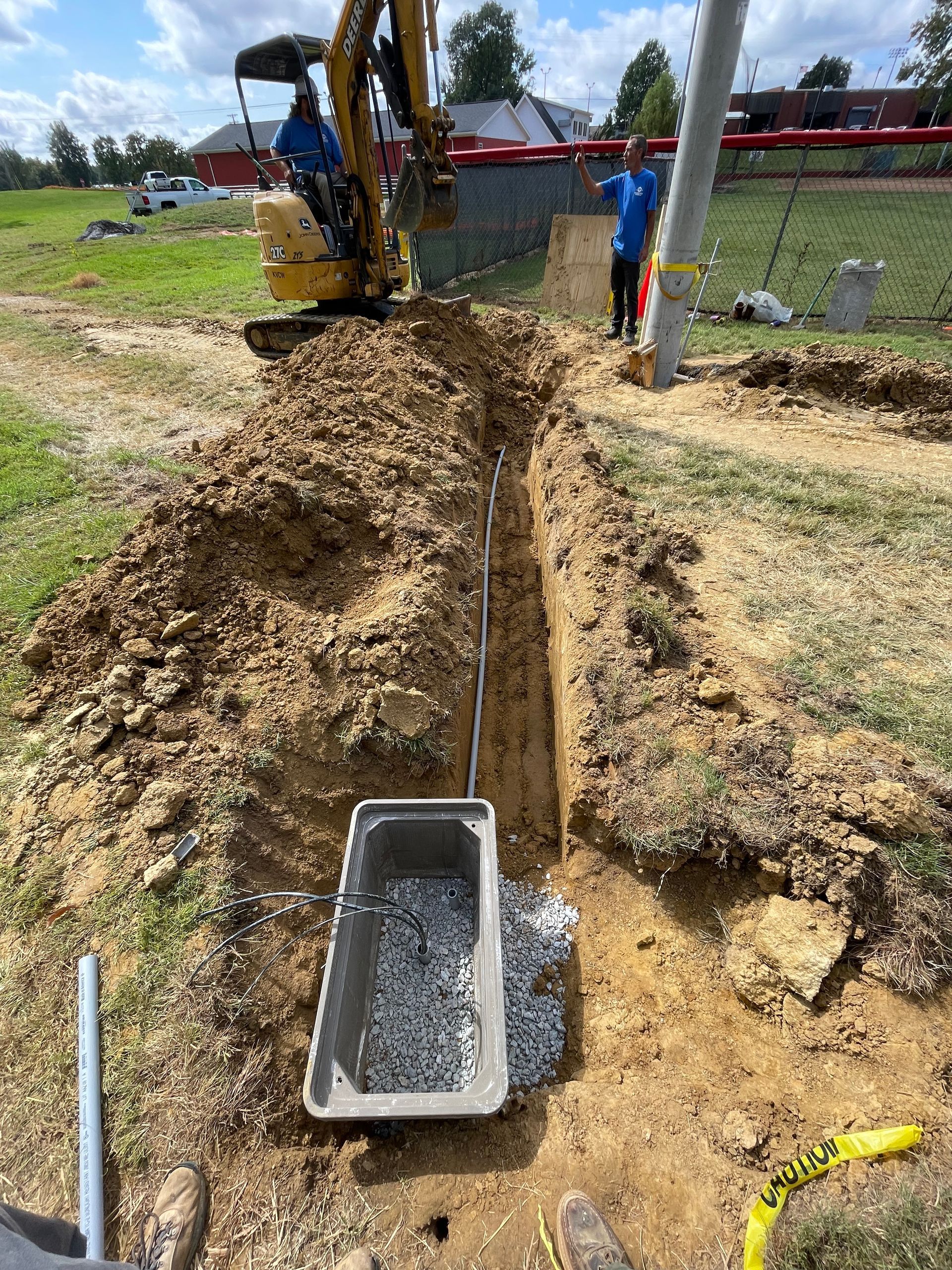 A man is digging a hole in the ground with a bulldozer.