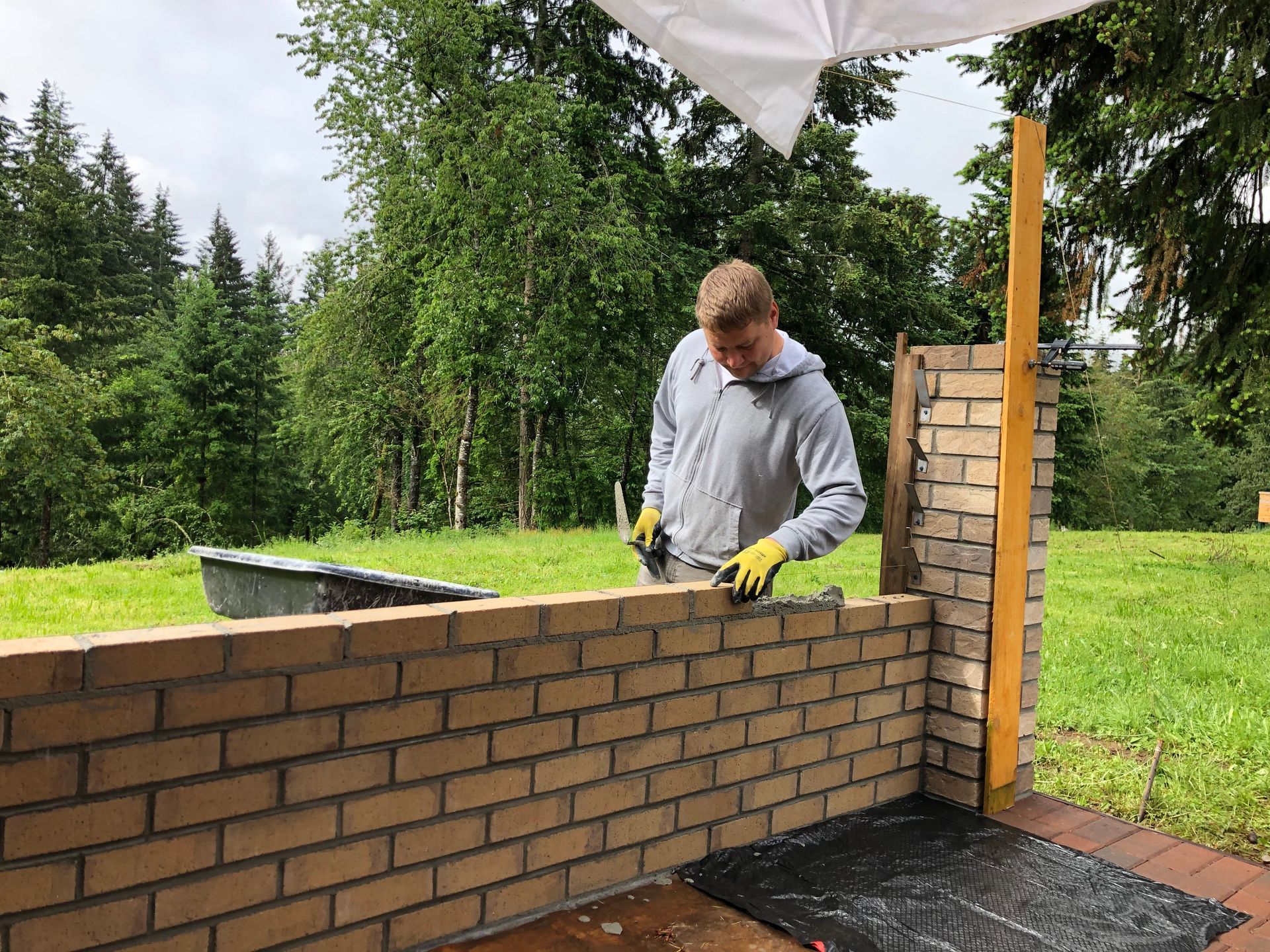 A carport is attached to the side of a house.
