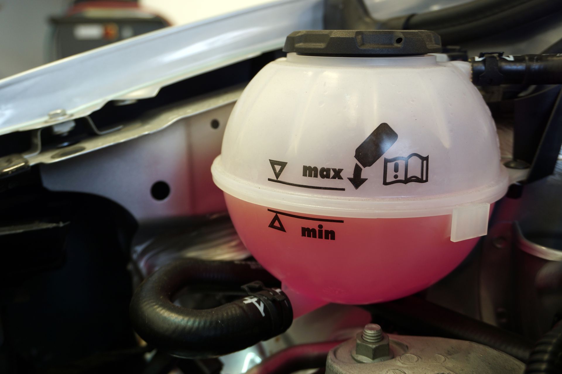 A close up of a coolant tank in a car