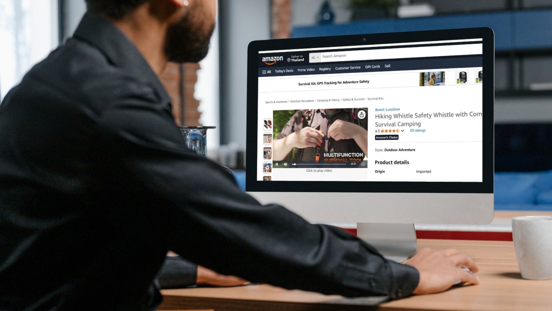 Person viewing LuxoGear Amazon product listing on a desktop screen with embedded product video.