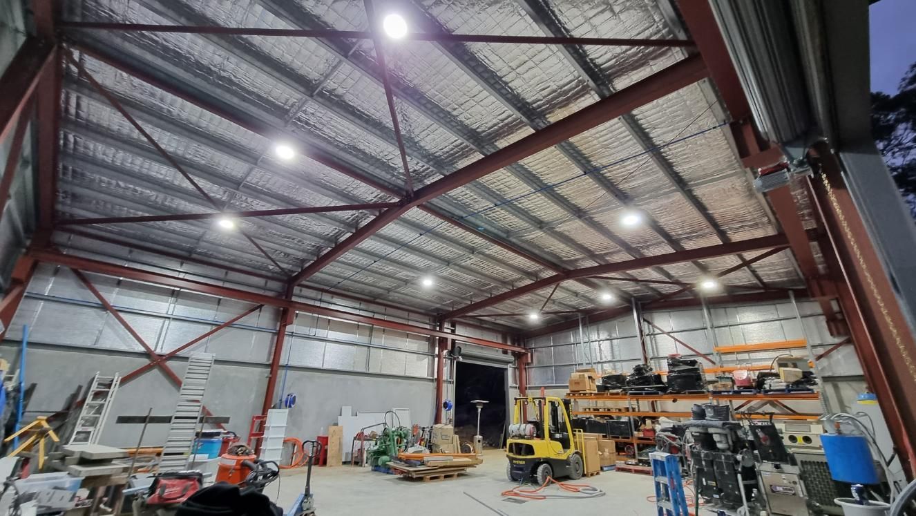 A Large Warehouse With A Lot Of Lights On The Ceiling — Licence To Spark In Bateau Bay, NSW