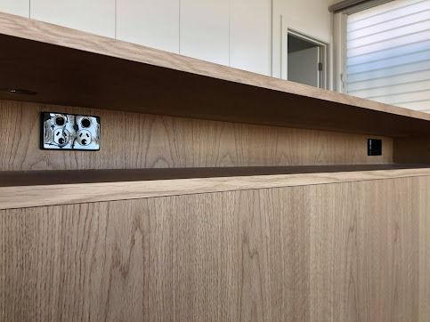 A Wooden Wall With Two Electrical Outlets On It — Licence To Spark In Lake Macquarie, NSW