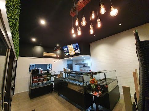 A Restaurant With A Lot Of Lights Hanging From The Ceiling — Licence To Spark In Bateau Bay, NSW