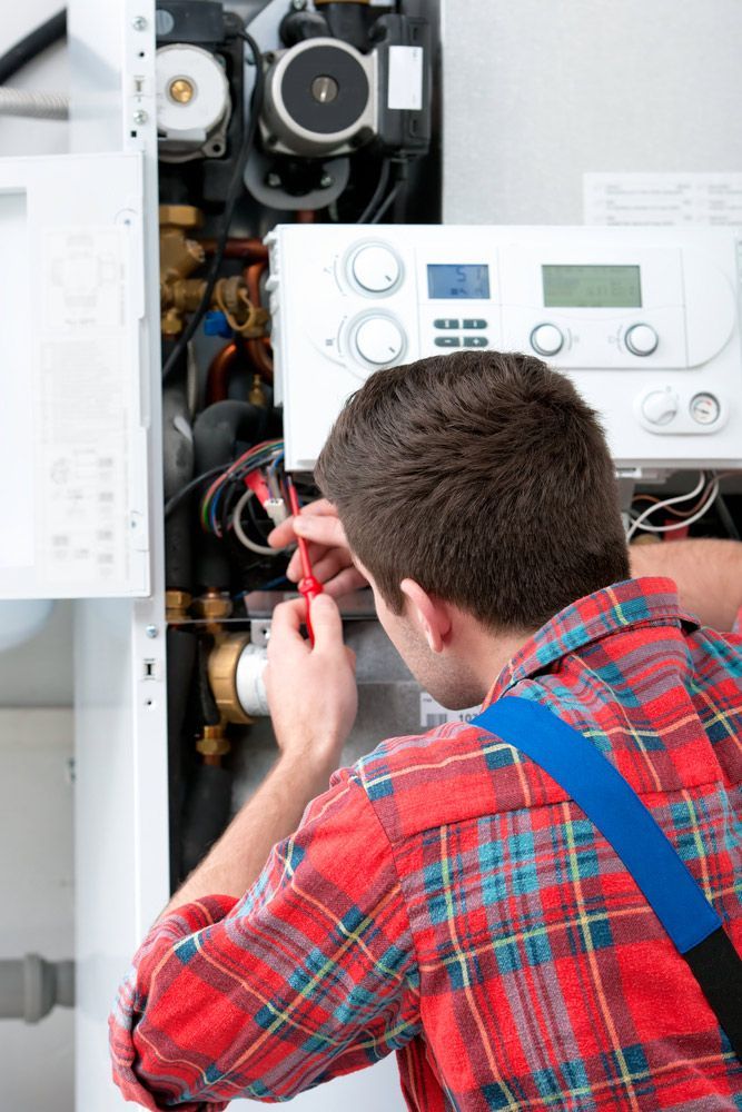 Electrician Repairing The Hot Water System — Electrician In Mundingburra, QLD
