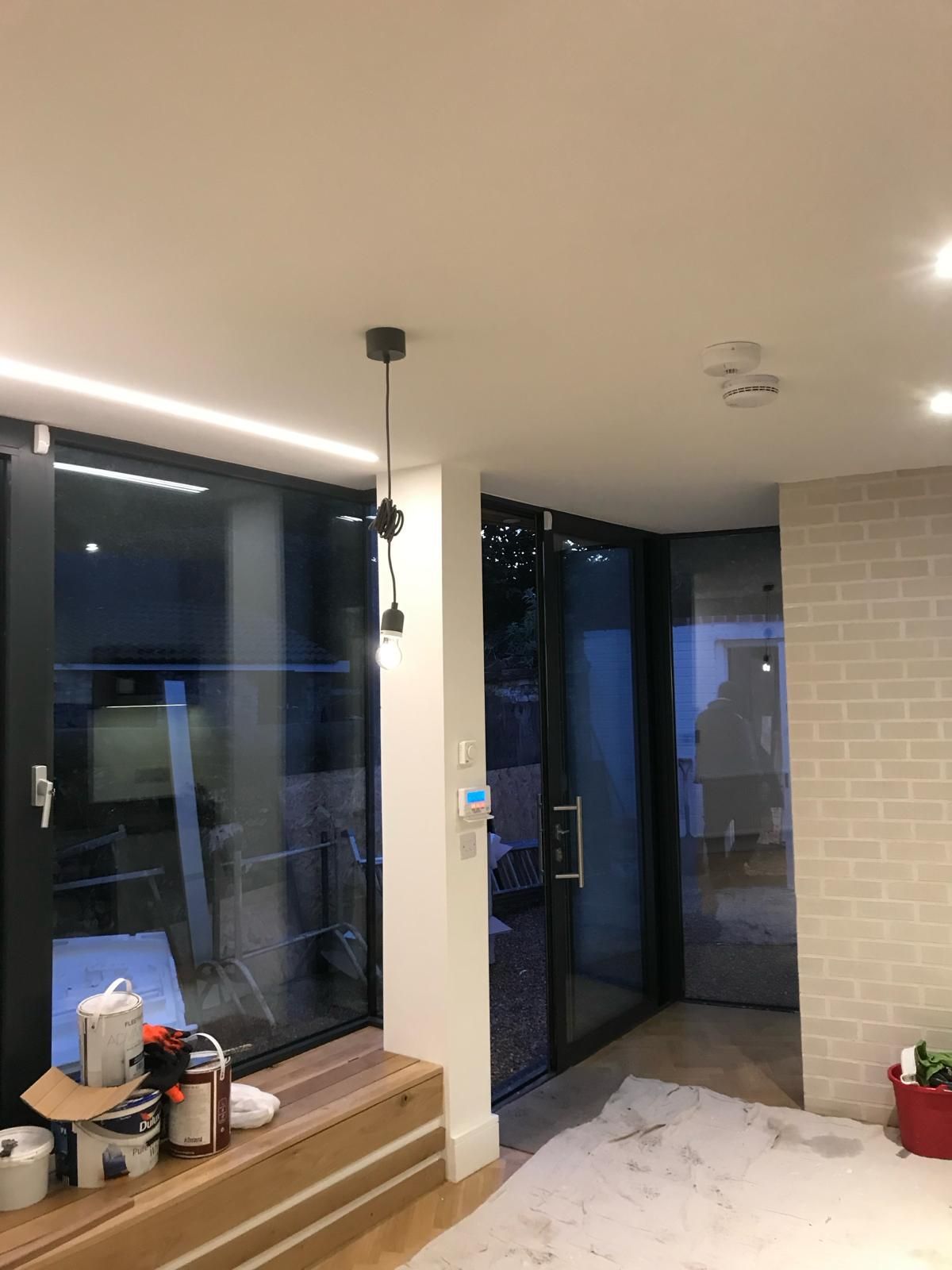 a living room with a large window and a sliding glass door .