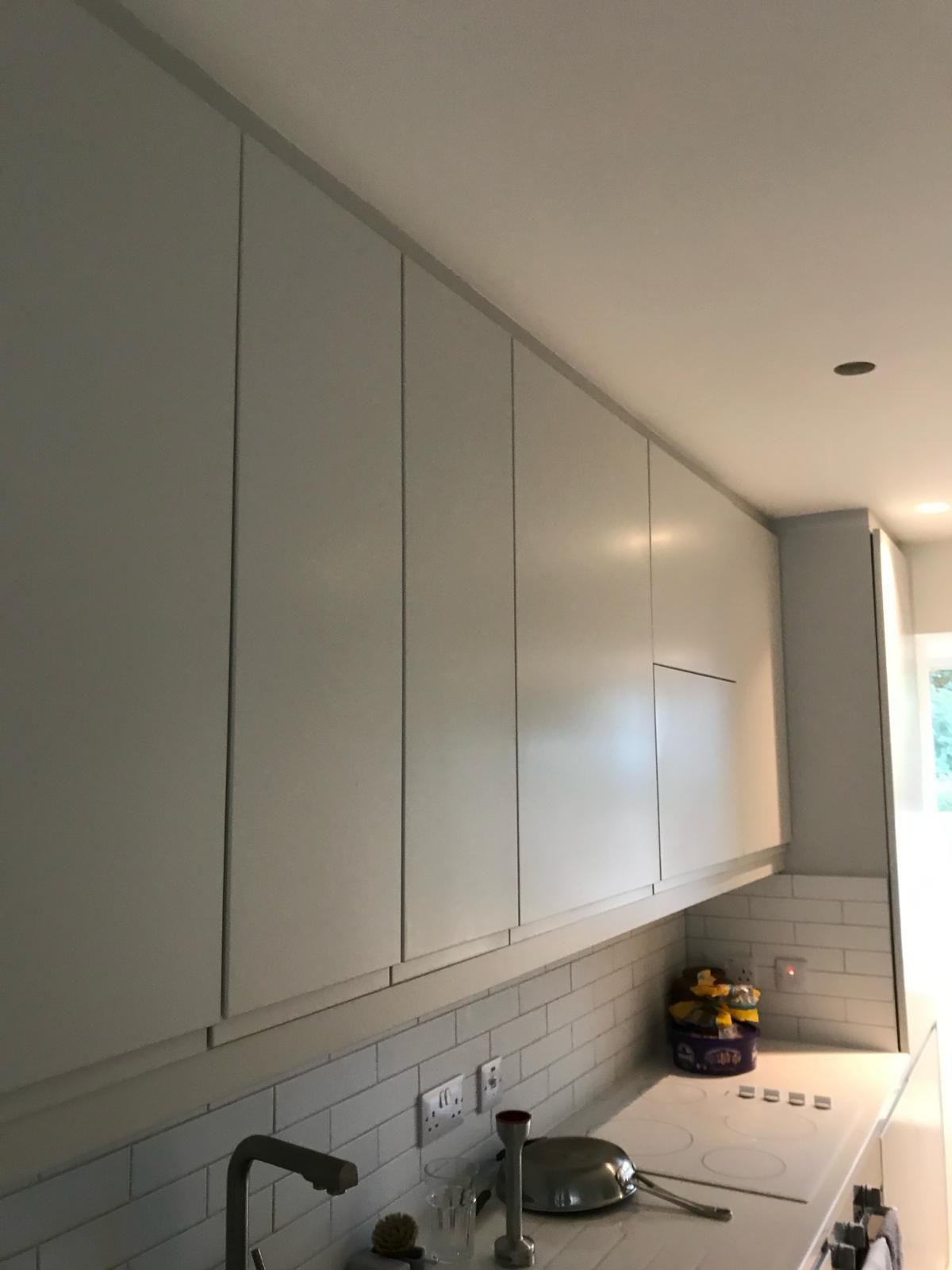 a kitchen with white cabinets and a sink