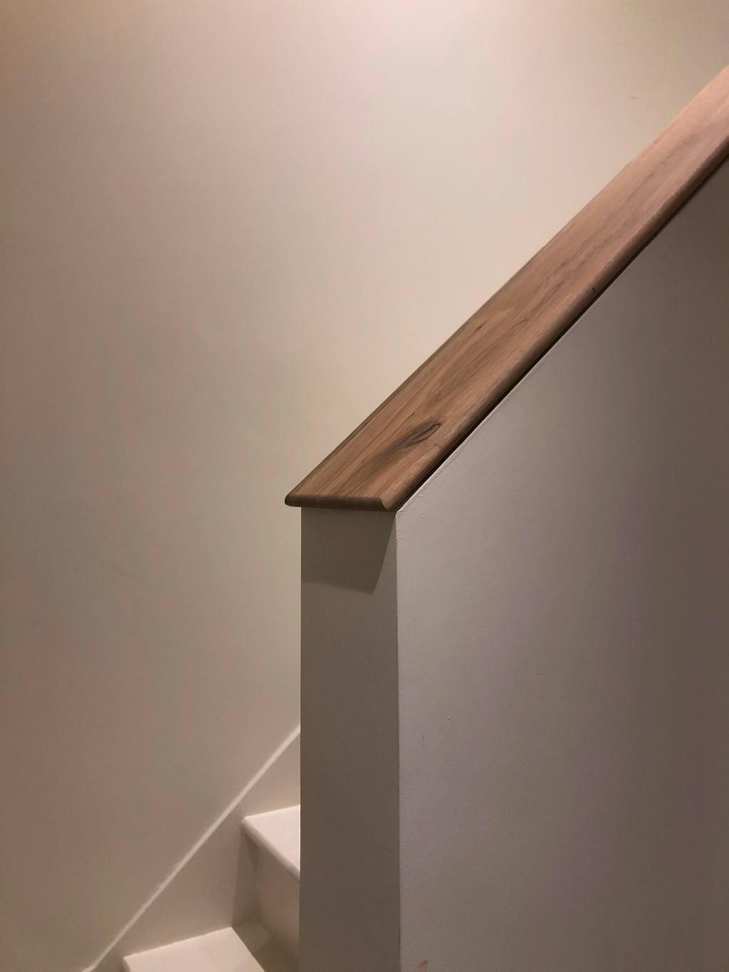 a close up of a wooden railing on a staircase .