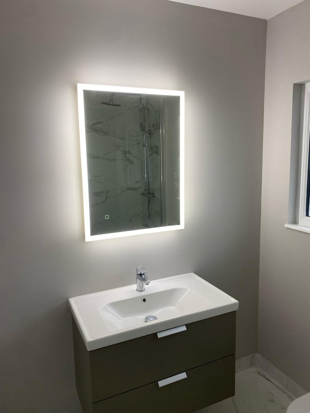 a bathroom with a sink , mirror and toilet .