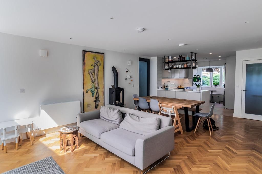 a living room with a couch , table and chairs .