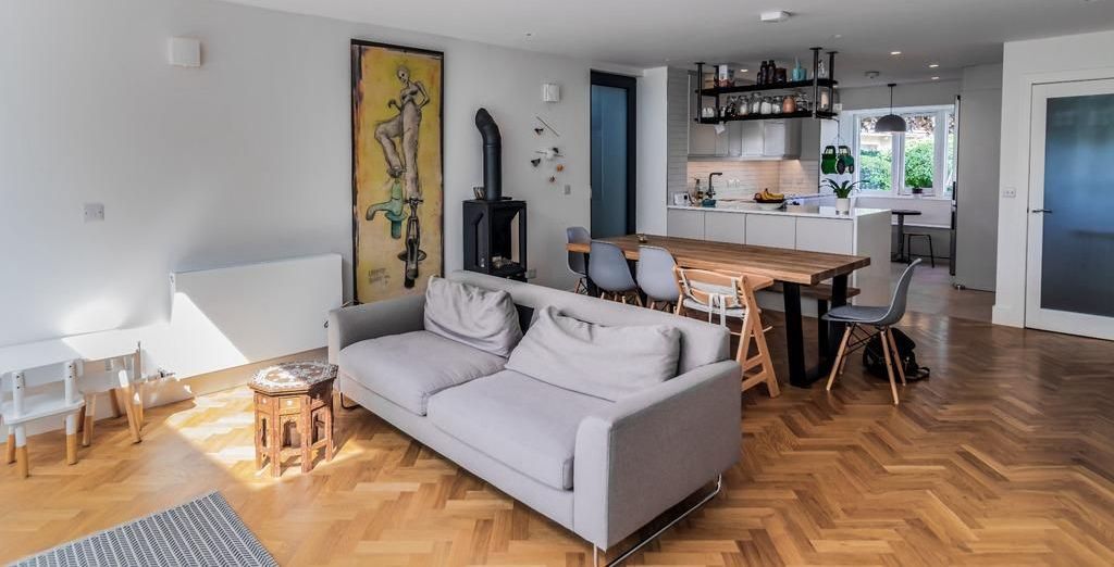 a living room with a couch , table and chairs .