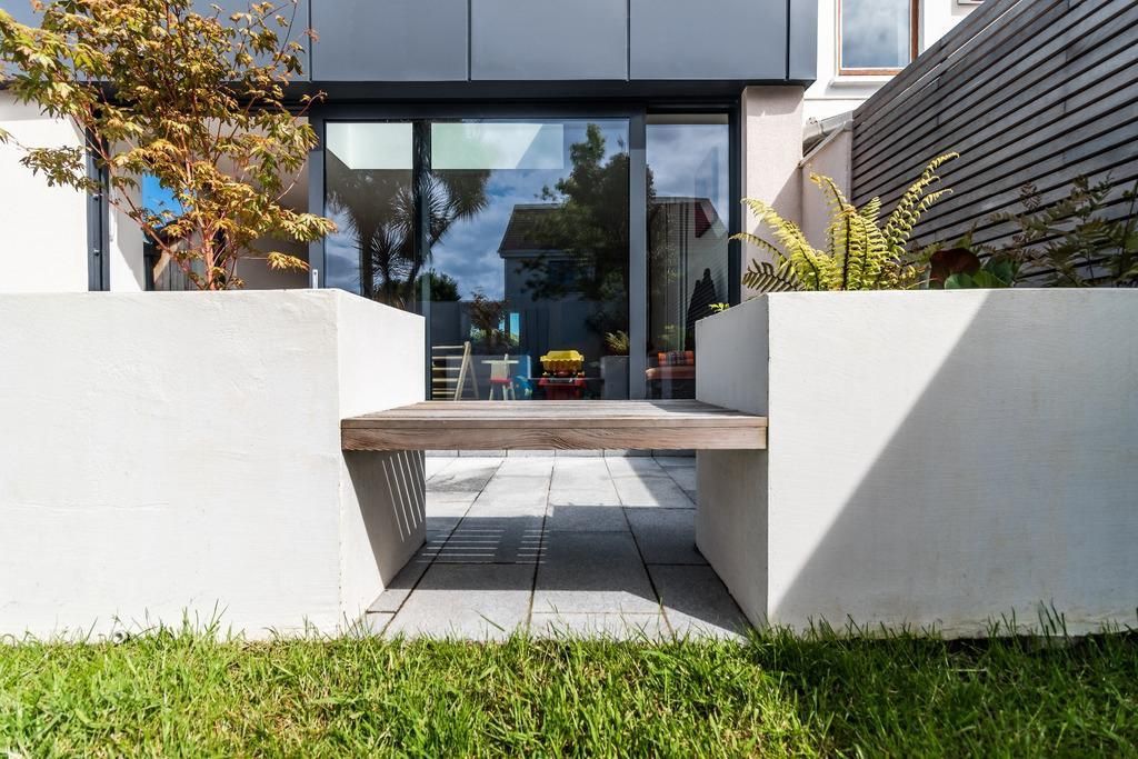 a house with a patio and a bench in front of it .