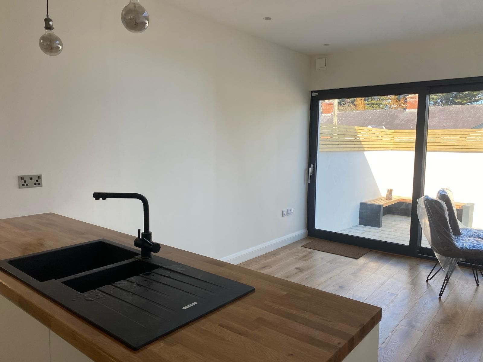 a kitchen with a sink and a sliding glass door