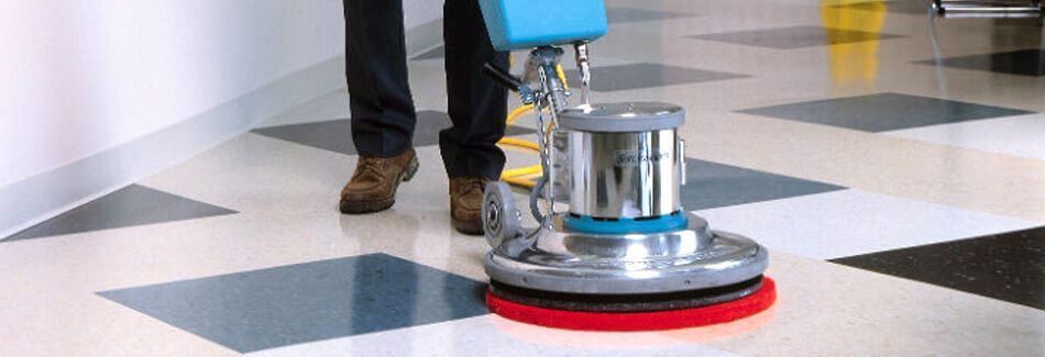 A Person Is Cleaning A Tiled Floor With A Machine — Tailored Services in Mackay Harbour, QLD