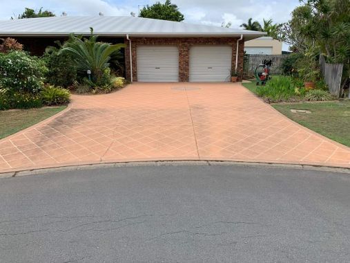 A Driveway Leading To A House With Two Garages — Tailored Services in Mackay Harbour, QLD