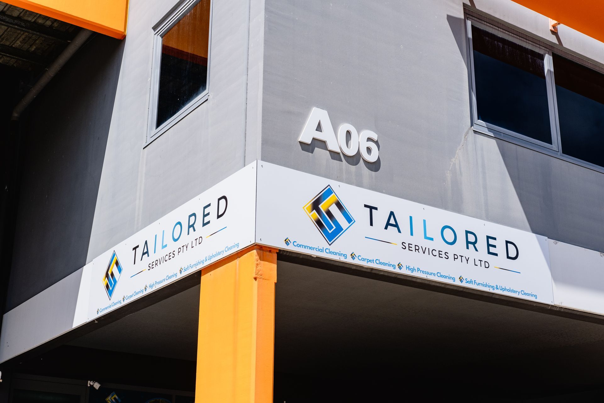 A Man Is Cleaning A Desk With A Computer And Keyboard — Tailored Services in Sarina, QLD