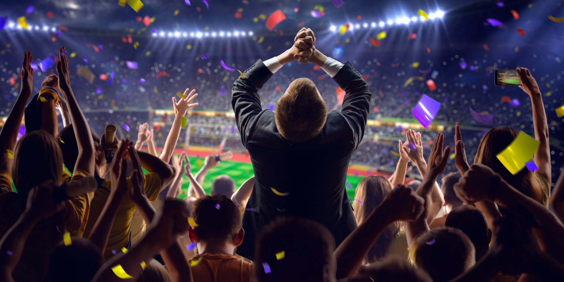 man cheering in the crowd of a stadium