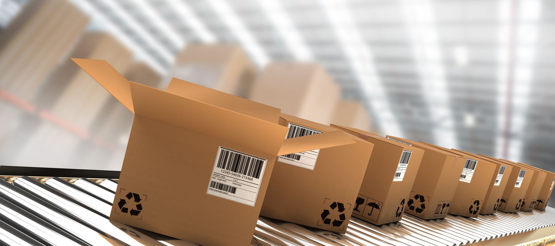 Row of cardboard boxes with barcodes moving along a conveyor in a warehouse. Row of cardboard boxes with barcodes moving along a conveyor in a warehouse.