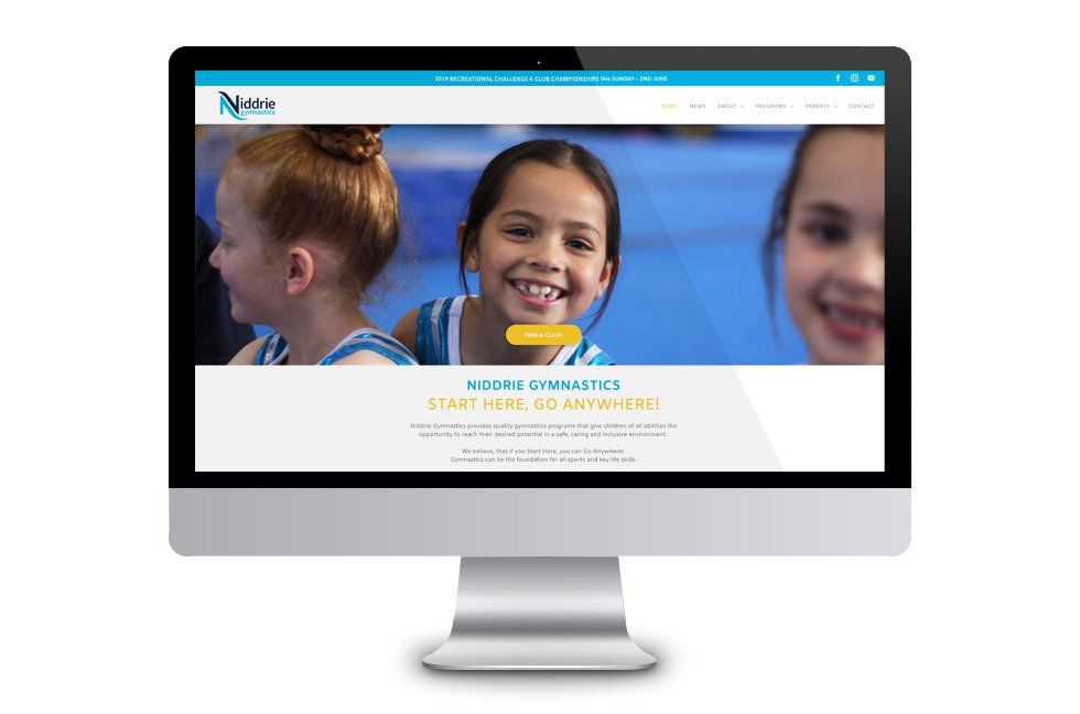 A computer monitor is displaying a website for a gymnastics school.