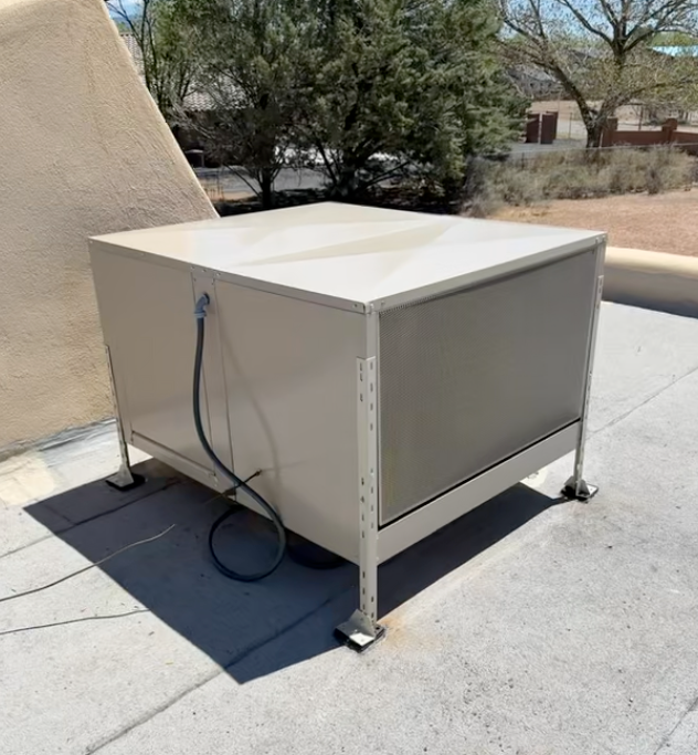 A box with a cord attached to it sits on a roof