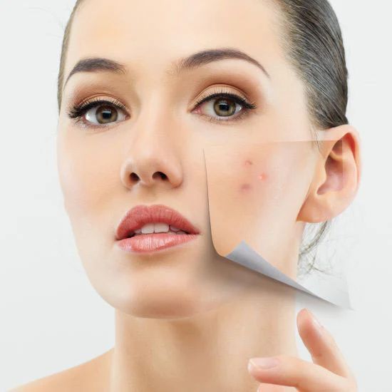 A woman is peeling off a piece of paper from her face.