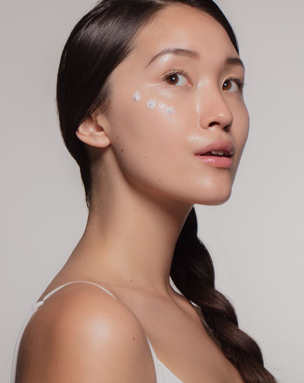 A woman is getting a facial treatment in a beauty salon.