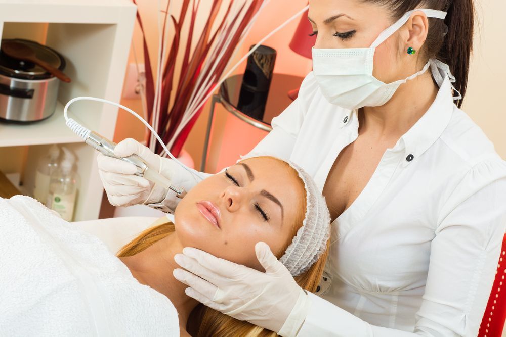 A woman is getting a facial treatment at a beauty salon.